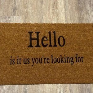 Coir Doormat with "Hello is it us you're looking for" painted on it